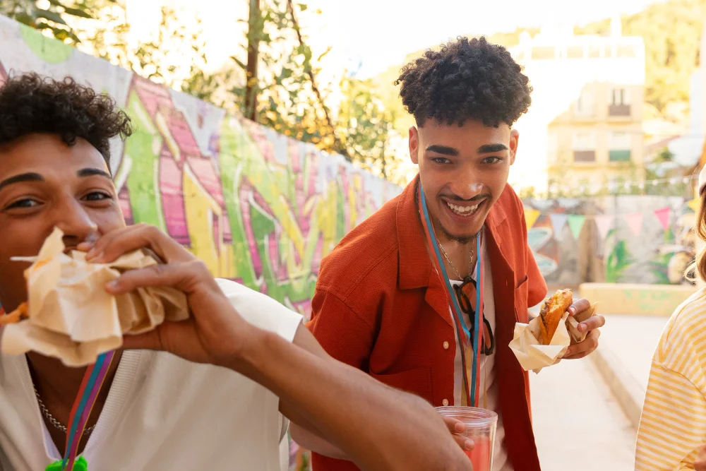2 boys eating street food